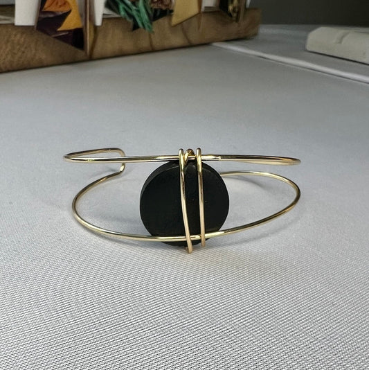 Gold open bangle bracelet with black bead by Madera Design Studio