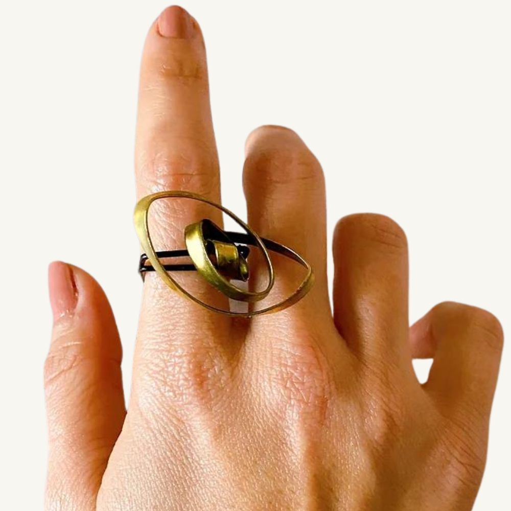 Bold recycled brass nest ring on a woman's finger