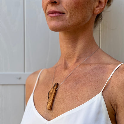 Upcycled olive wood beads handmade by Madera Design Studio on sterling silver chain on model in Croatia