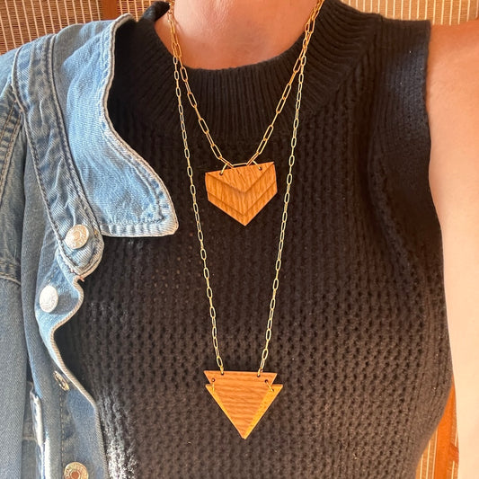 Layered double triangle recycled oak necklace on model in black shirt and jean jacket