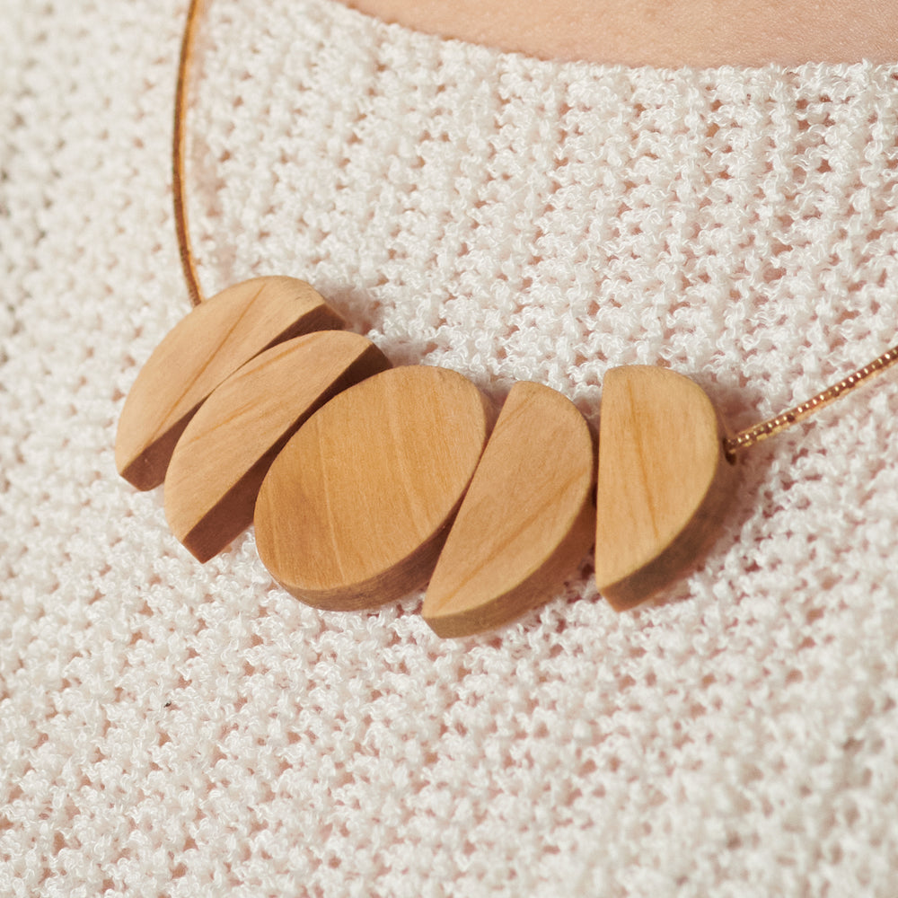 Light moon wooden necklace on gold chain by Madera Design Studio