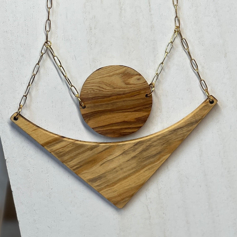 two piece necklace with a circle and triangle shaped olive wood on a gold paper clip chain.