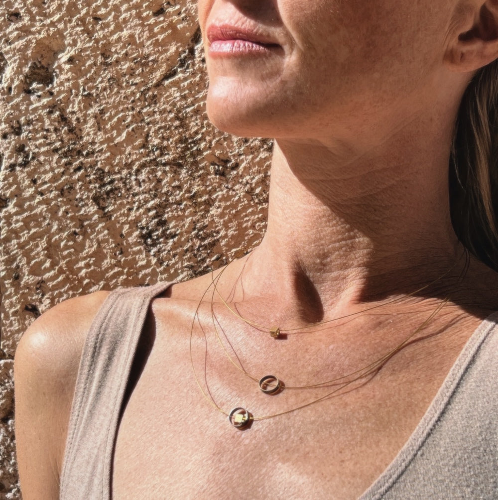 Gold Plated Persona Necklace, handmade, recycled steel. On model. Madera Design Studio collab with Lit Clue