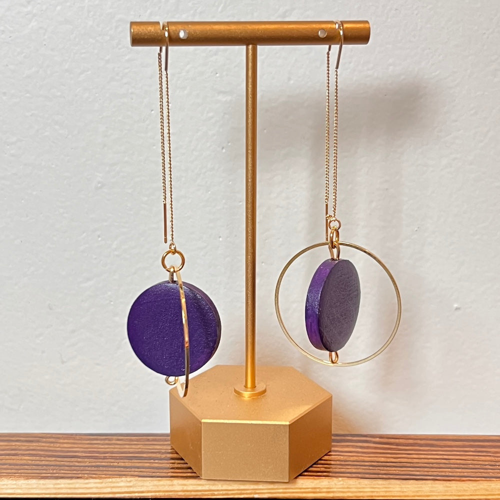 hand painted purple threader earrings on a gold stand on a white background. Made by Madera Design Studio