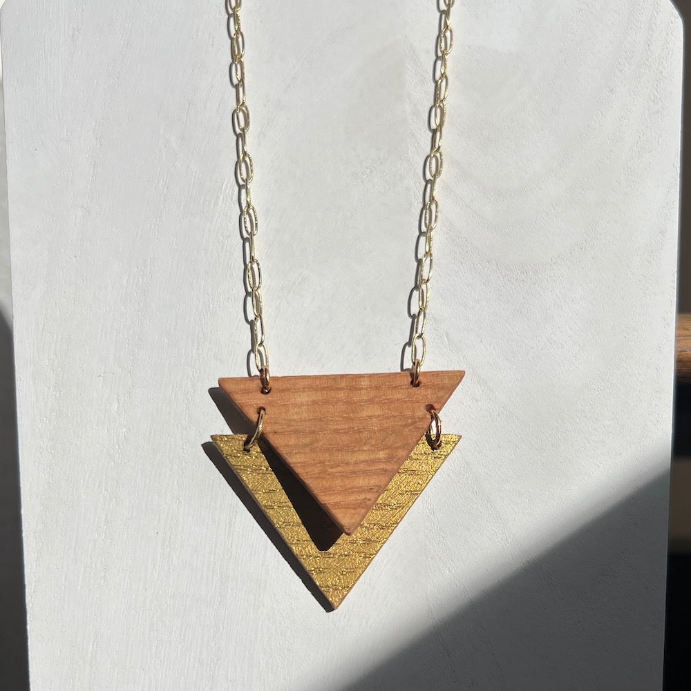 Handmade recycled oak triangles necklace. Two triangles overlapping on white background